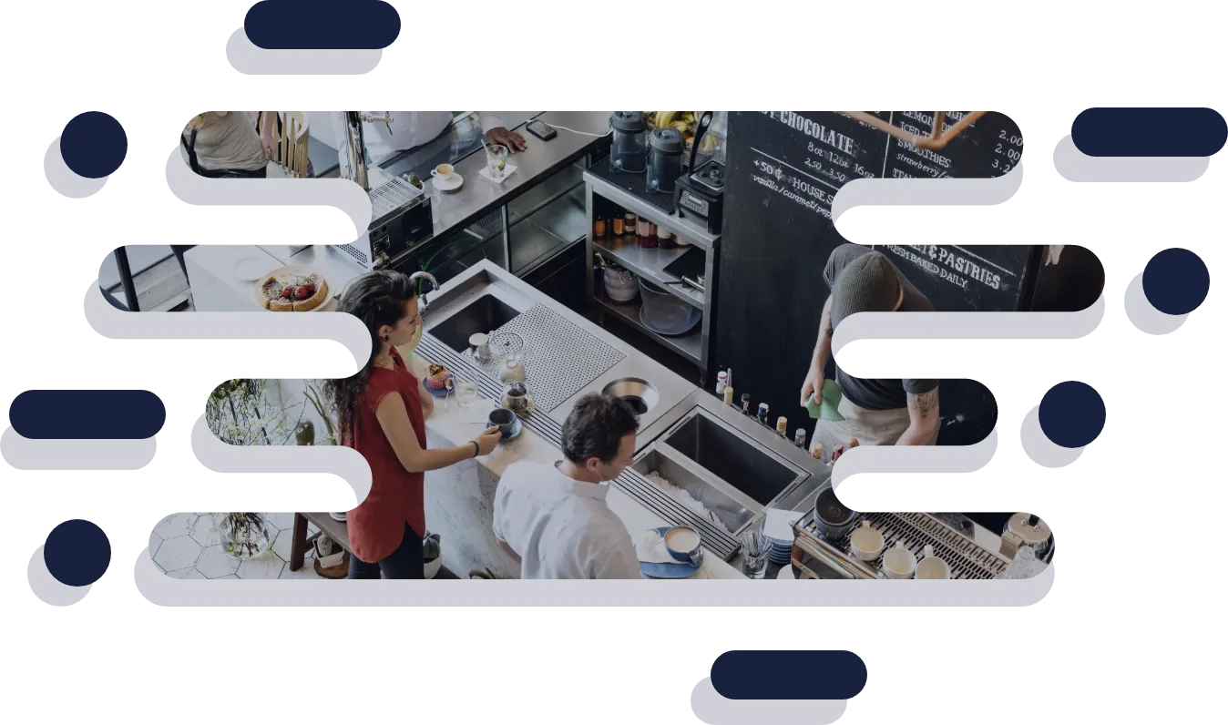 image of people at a cafe counter with a barista making drinks and a chalkboard menu in the background, in a frame